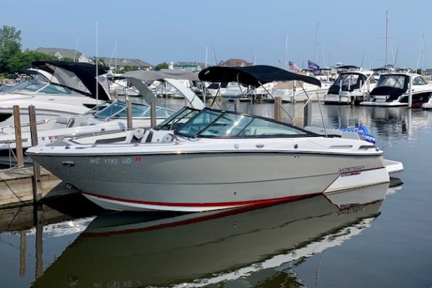 a small boat docked next to a body of water