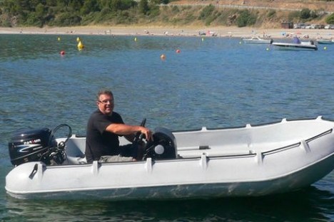 a man with a small boat in a body of water