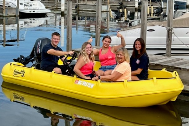 a group of people on a boat in the water